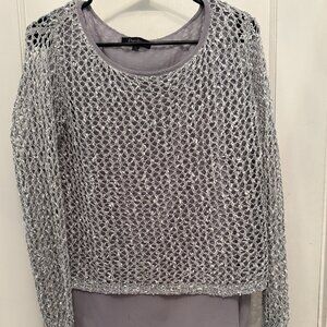 A SILVER FISHTOP THAT SHIMMERS WITH METALICE SHEEN THAT FEELS EDGY AND ELEGANT.